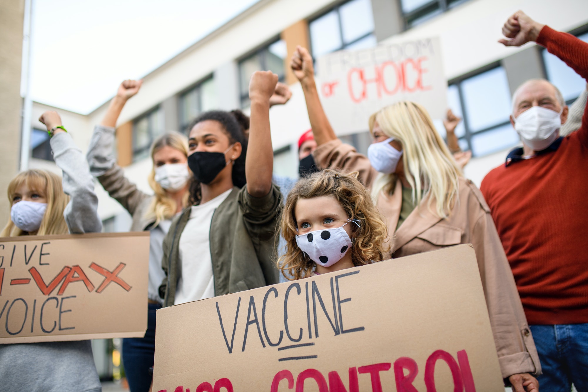 People with placards and posters on public demonstration, no covid vaccine concept